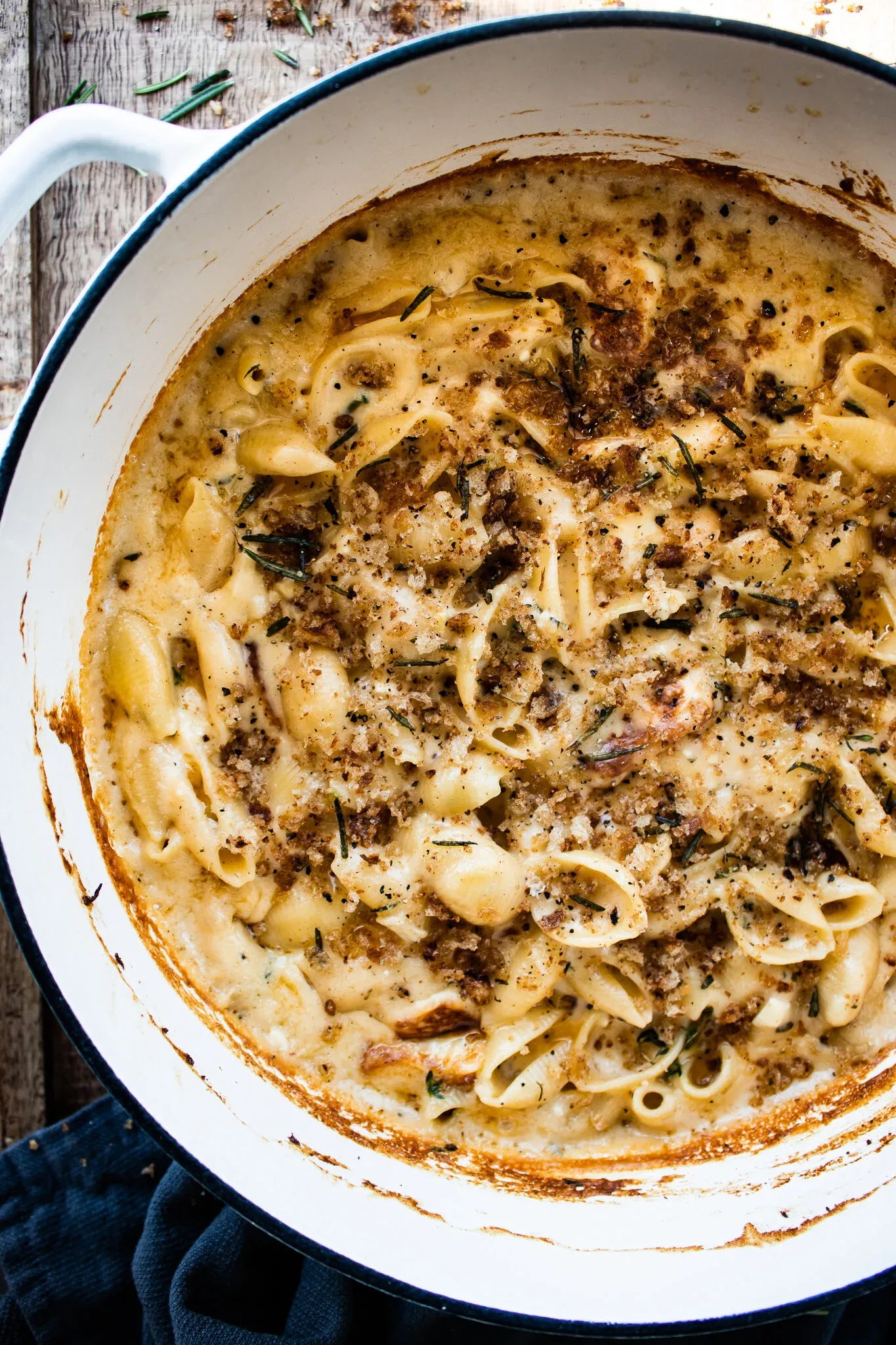 Creamy 7 Cheese Herb and Garlic Baked Mac and Cheese fresh from the oven in a white enamel Dutch oven