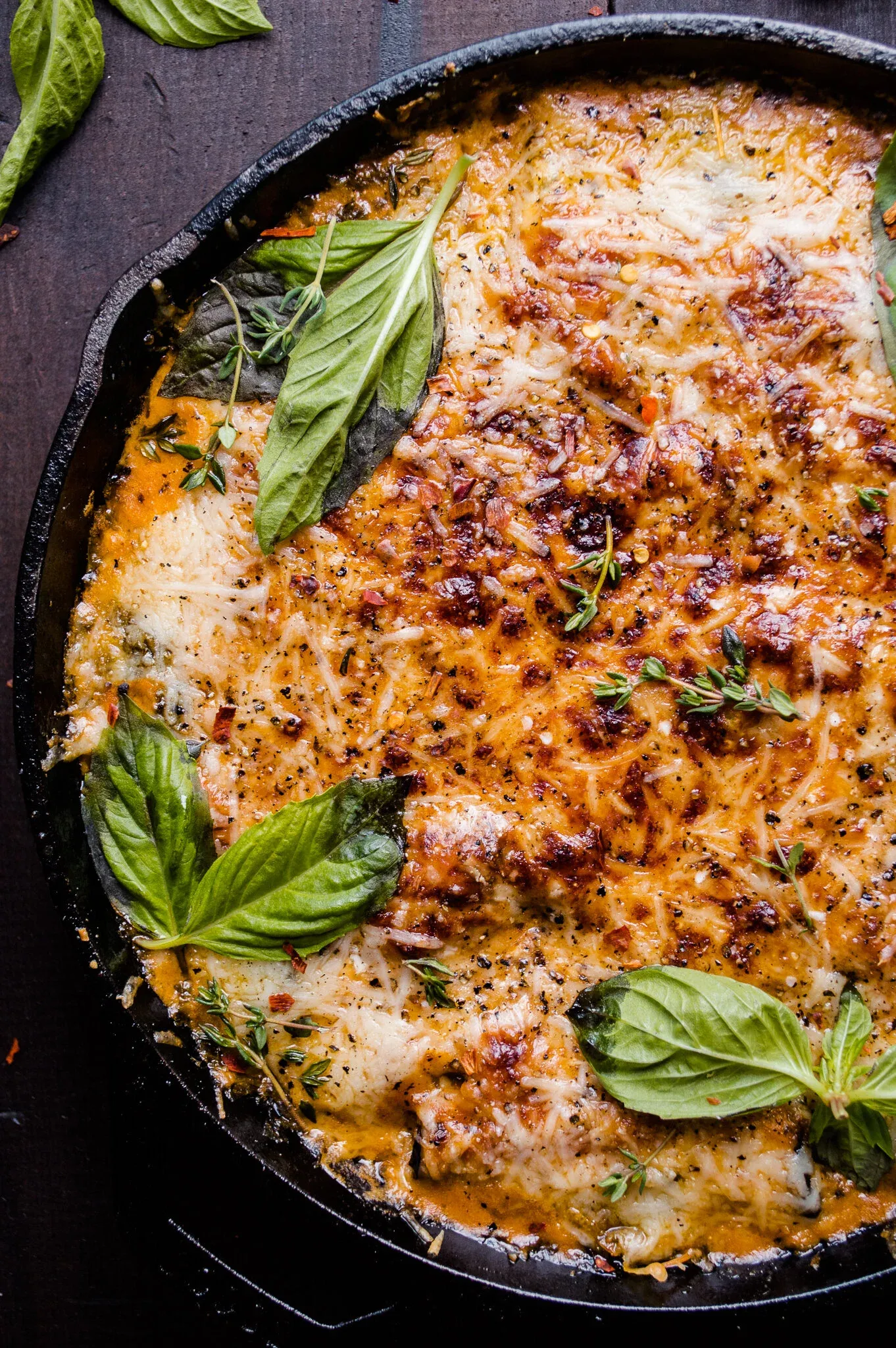 Overhead close-up of Eggplant Involtini baked in a black cast iron skillet